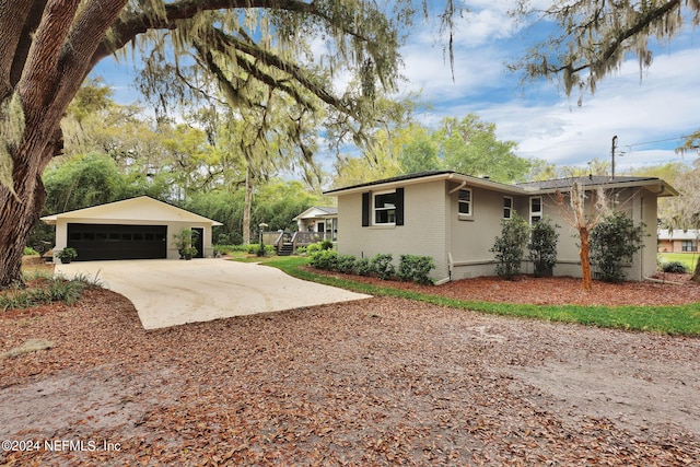 3079 Anderson Rd, Green Cove Springs, FL 32043 - view of side of property featuring a detached garage, brick siding, and an outdoor structure