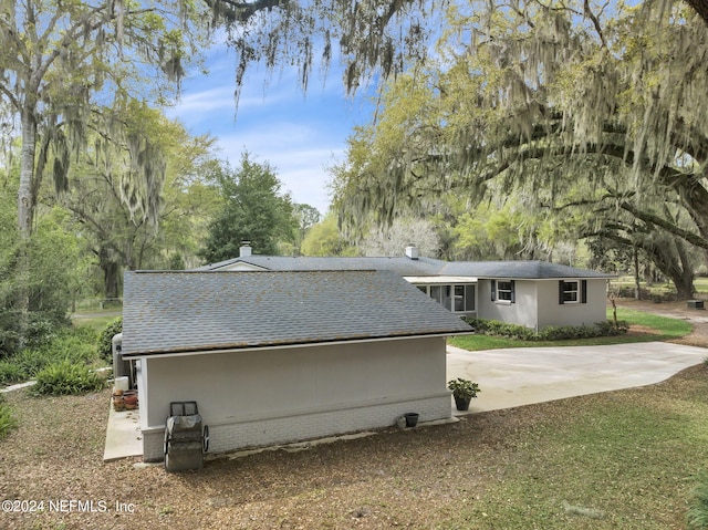 3079 Anderson Rd, Green Cove Springs, FL 32043 - rear view of property featuring stucco siding and roof with shingles