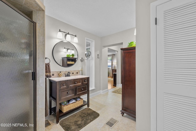 3079 Anderson Rd, Green Cove Springs, FL 32043 - bathroom featuring visible vents, a shower stall, a textured ceiling, and vanity