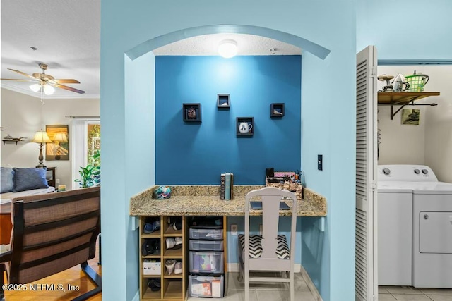 interior space featuring tile patterned floors, a ceiling fan, and separate washer and dryer