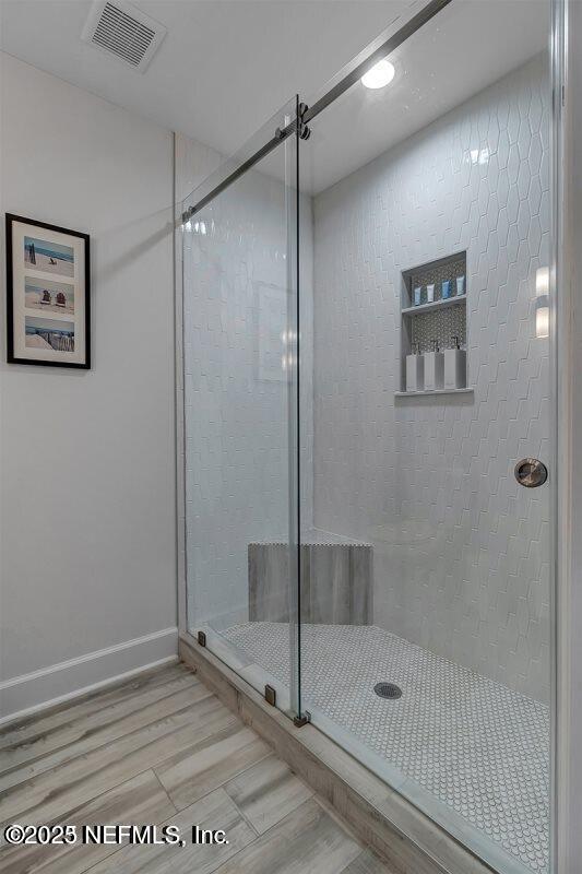 726 Spinnakers Reach Dr Unit 726, Ponte Vedra Beach, FL 32082 - full bathroom featuring baseboards, a stall shower, wood finished floors, and visible vents