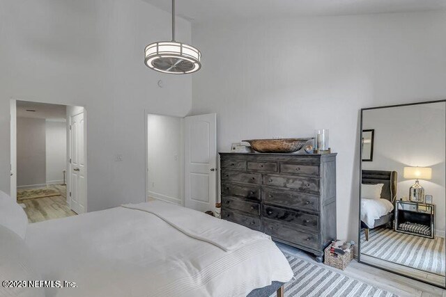 726 Spinnakers Reach Dr Unit 726, Ponte Vedra Beach, FL 32082 - bedroom featuring wood finished floors, baseboards, and a high ceiling