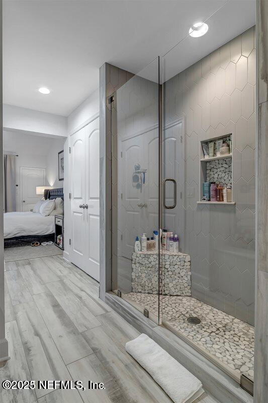 726 Spinnakers Reach Dr Unit 726, Ponte Vedra Beach, FL 32082 - ensuite bathroom with ensuite bathroom, a stall shower, recessed lighting, and wood finished floors