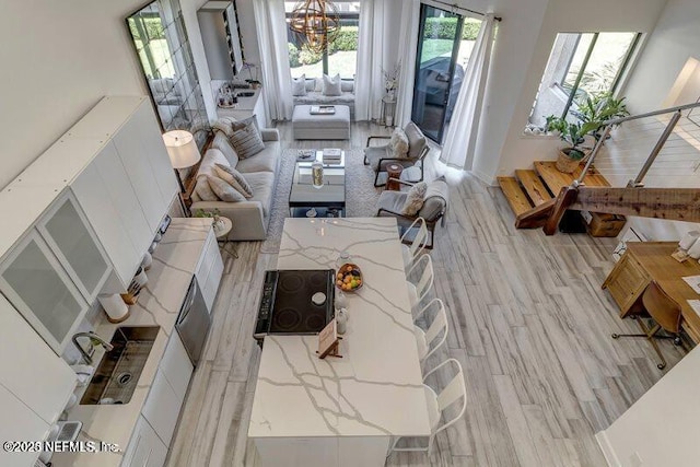 726 Spinnakers Reach Dr Unit 726, Ponte Vedra Beach, FL 32082 - living area featuring light wood-type flooring and an inviting chandelier