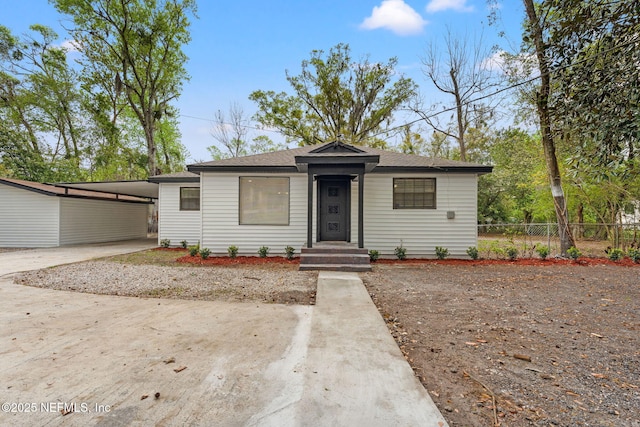6211 Firestone Rd, Jacksonville, FL 32244 - bungalow with an attached carport, fence, and driveway