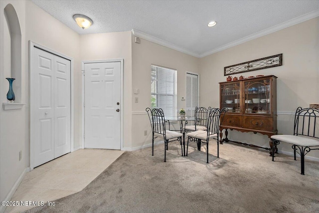 10000 Gate Pkwy Unit 714, Jacksonville, FL 32246 - dining room with ornamental molding, a textured ceiling, arched walkways, carpet flooring, and baseboards