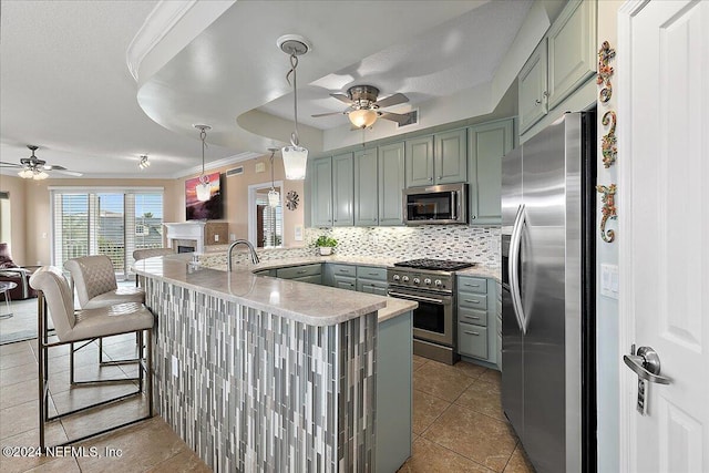 116 19th Ave N Unit 301, Jacksonville Beach, FL 32250 - kitchen featuring tasteful backsplash, open floor plan, stainless steel appliances, a peninsula, and ceiling fan