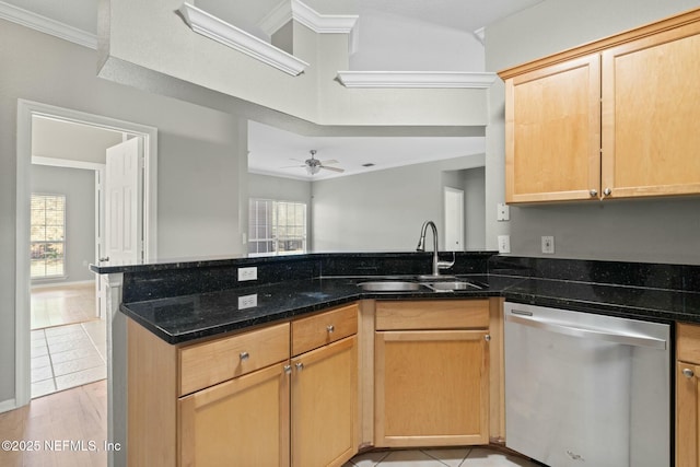 kitchen featuring dishwasher, a peninsula, a healthy amount of sunlight, and a sink