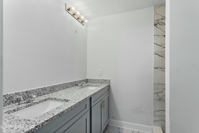 1539 E 26th St, Jacksonville, FL 32206 - bathroom with a sink, a textured ceiling, marble finish floor, and double vanity