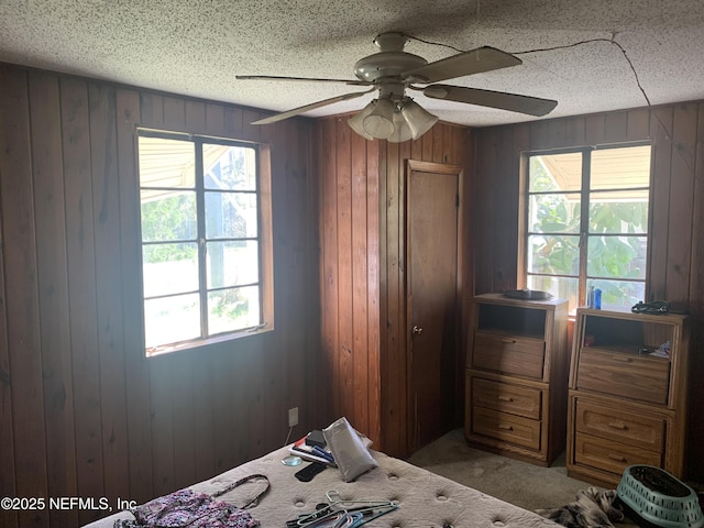 7823 Berry Ave, Jacksonville, FL 32211 - unfurnished bedroom featuring carpet, wood walls, and a textured ceiling