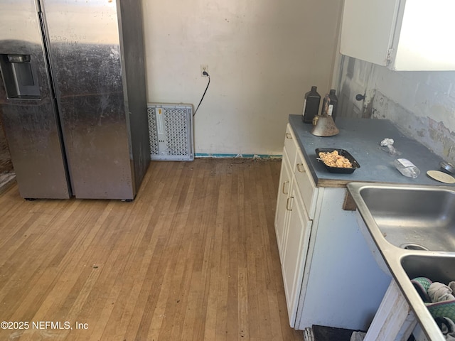 7823 Berry Ave, Jacksonville, FL 32211 - kitchen featuring a sink, white cabinets, and light wood finished floors