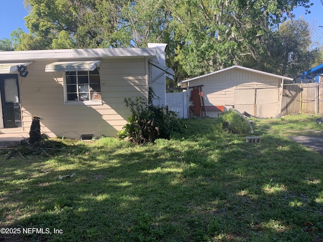 7823 Berry Ave, Jacksonville, FL 32211 - view of side of home featuring fence and a lawn