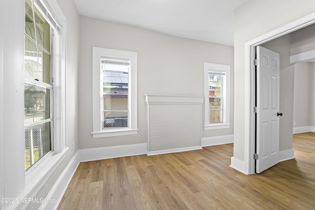 unfurnished room featuring baseboards and wood finished floors