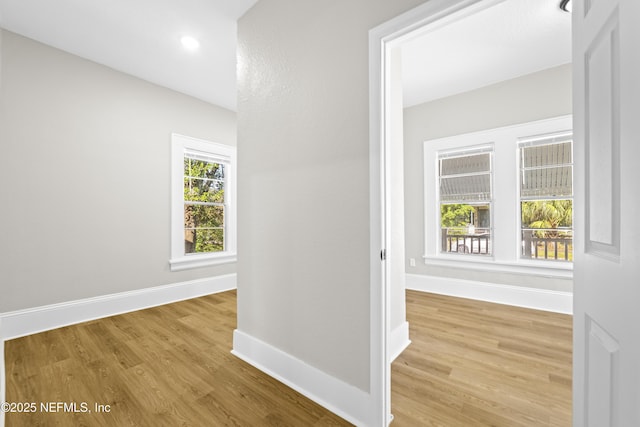 hallway with recessed lighting, baseboards, and wood finished floors