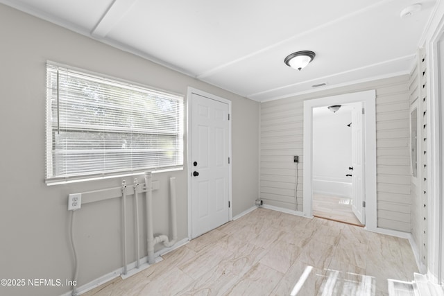 entryway with wood walls