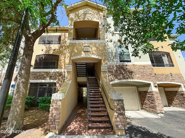 8539 Gate Pkwy W Unit 628, Jacksonville, FL 32216 - view of property with stairway and an attached garage