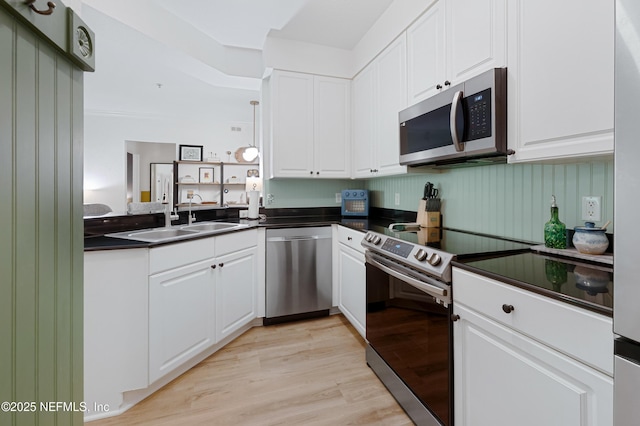 8539 Gate Pkwy W Unit 628, Jacksonville, FL 32216 - kitchen with a sink, dark countertops, white cabinetry, and stainless steel appliances