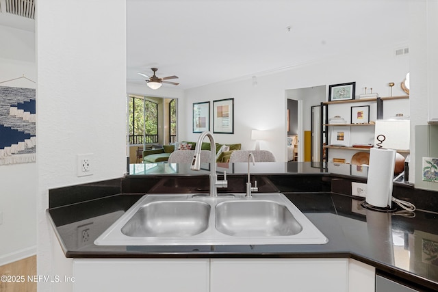 8539 Gate Pkwy W Unit 628, Jacksonville, FL 32216 - kitchen with a sink, visible vents, dark countertops, and ceiling fan