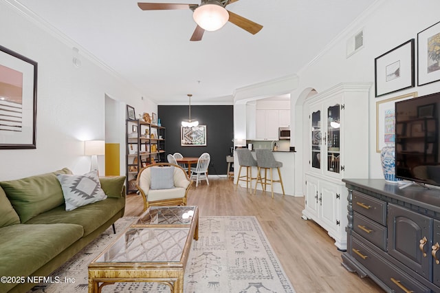 8539 Gate Pkwy W Unit 628, Jacksonville, FL 32216 - living room with ceiling fan with notable chandelier, visible vents, light wood finished floors, and ornamental molding