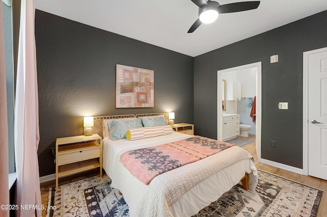 8539 Gate Pkwy W Unit 628, Jacksonville, FL 32216 - bedroom featuring light wood-type flooring, baseboards, connected bathroom, and a ceiling fan