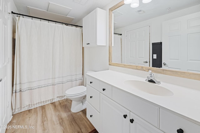 8539 Gate Pkwy W Unit 628, Jacksonville, FL 32216 - bathroom with visible vents, toilet, wood finished floors, and vanity