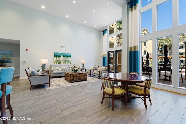 8539 Gate Pkwy W Unit 628, Jacksonville, FL 32216 - dining area featuring recessed lighting, light wood-style flooring, visible vents, and a towering ceiling