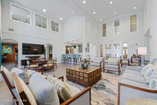 8539 Gate Pkwy W Unit 628, Jacksonville, FL 32216 - living area featuring light wood finished floors, visible vents, baseboards, recessed lighting, and arched walkways