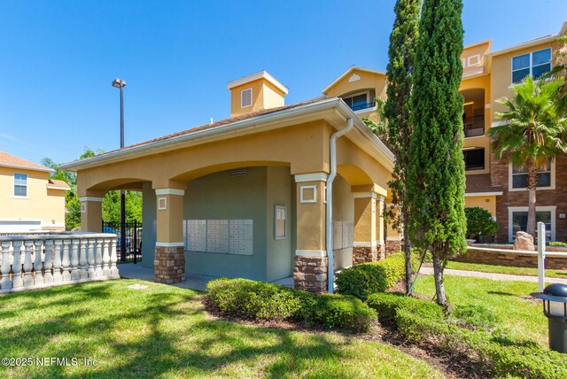 8539 Gate Pkwy W Unit 628, Jacksonville, FL 32216 - exterior space featuring mail area and a lawn