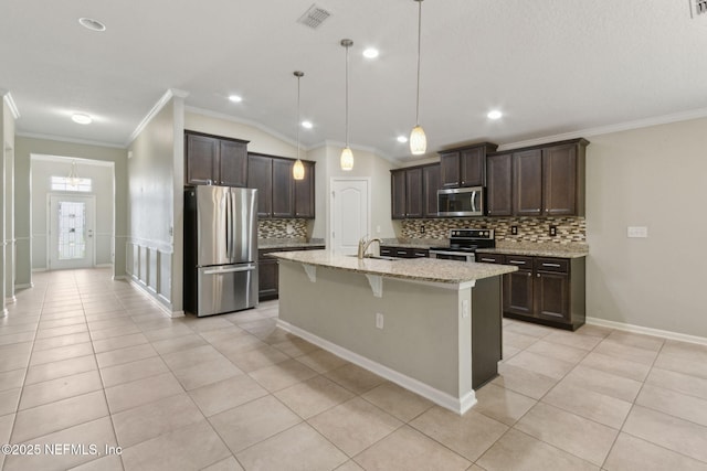 79 Boulder Rock Way, Saint Augustine, FL 32092 - kitchen with stainless steel appliances, tasteful backsplash, ornamental molding, dark brown cabinets, and a kitchen bar