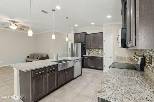 79 Boulder Rock Way, Saint Augustine, FL 32092 - kitchen with stainless steel appliances, a sink, decorative backsplash, light tile patterned floors, and ornamental molding