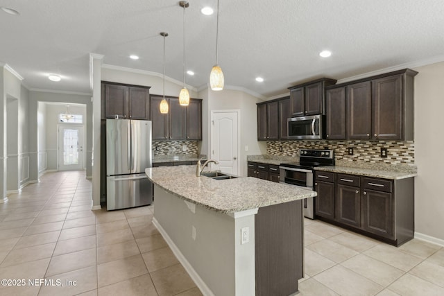 79 Boulder Rock Way, Saint Augustine, FL 32092 - kitchen with appliances with stainless steel finishes, a sink, light tile patterned floors, dark brown cabinets, and crown molding