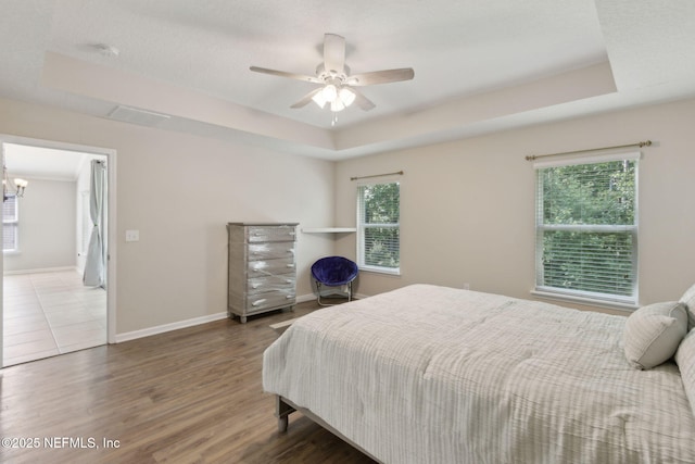 79 Boulder Rock Way, Saint Augustine, FL 32092 - bedroom featuring a raised ceiling, wood finished floors, baseboards, a chandelier, and ceiling fan