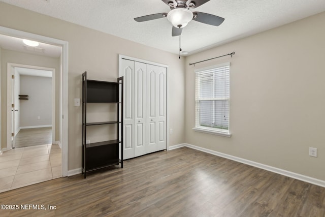 79 Boulder Rock Way, Saint Augustine, FL 32092 - unfurnished bedroom with a closet, wood finished floors, baseboards, and a textured ceiling