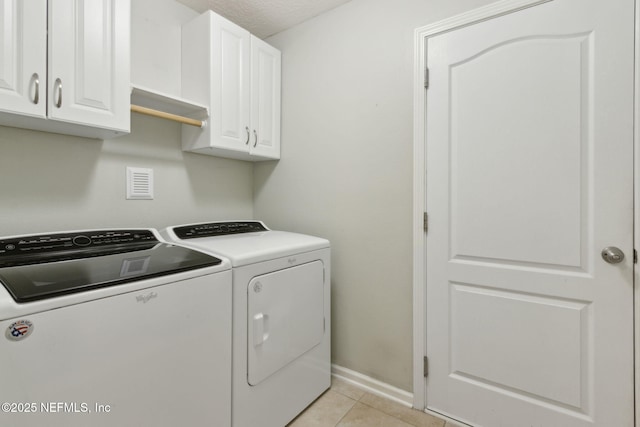 79 Boulder Rock Way, Saint Augustine, FL 32092 - laundry room featuring washing machine and clothes dryer, cabinet space, light tile patterned floors, and baseboards
