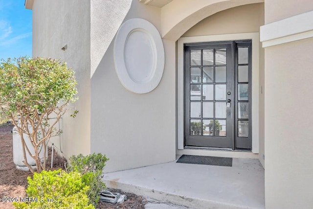 95332 Village Dr, Fernandina Beach, FL 32034 - doorway to property featuring stucco siding