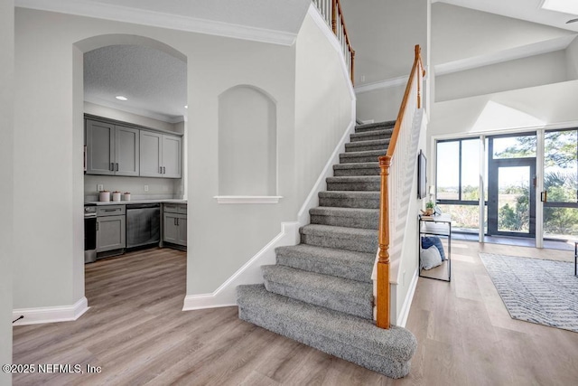 95332 Village Dr, Fernandina Beach, FL 32034 - stairs with arched walkways, crown molding, baseboards, and wood finished floors