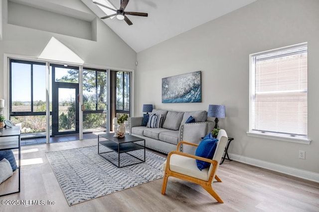 95332 Village Dr, Fernandina Beach, FL 32034 - living area featuring wood finished floors, baseboards, high vaulted ceiling, and ceiling fan