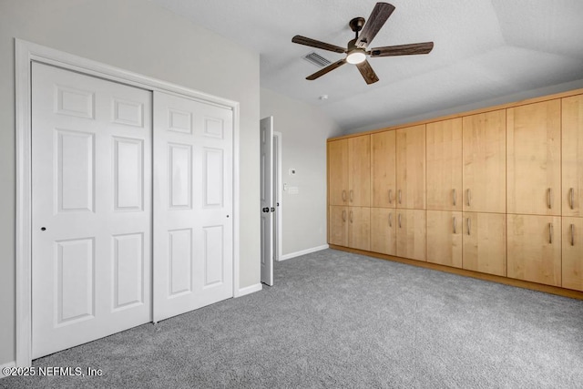 95332 Village Dr, Fernandina Beach, FL 32034 - unfurnished bedroom featuring visible vents, a closet, carpet floors, lofted ceiling, and ceiling fan