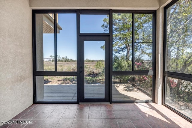 95332 Village Dr, Fernandina Beach, FL 32034 - unfurnished sunroom featuring tile patterned floors and a textured wall
