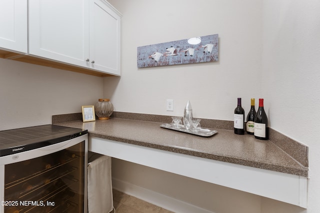 interior space featuring tile patterned floors, wine cooler, and a dry bar