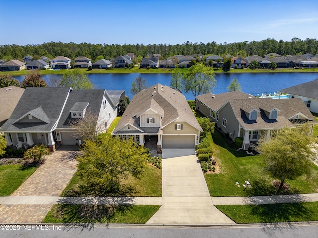 birds eye view of property with a residential view and a water view