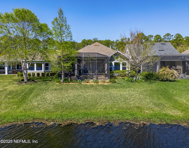 exterior space featuring a water view, a lanai, and a lawn