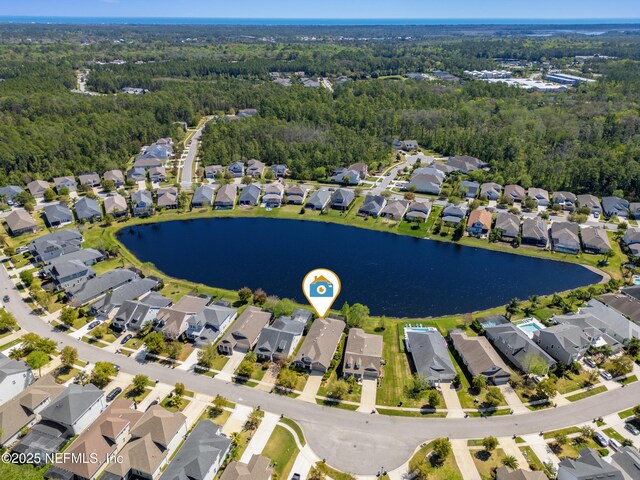 birds eye view of property with a residential view and a water view