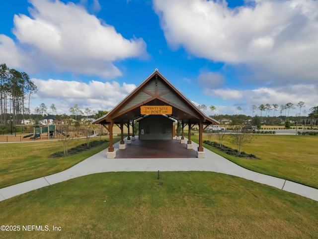 view of home's community featuring a lawn and playground community