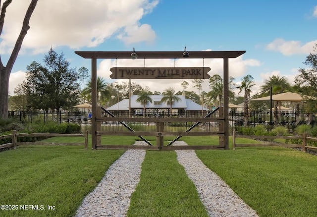 surrounding community with a lawn and fence