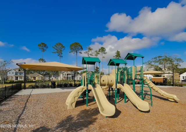 community play area with fence and a residential view