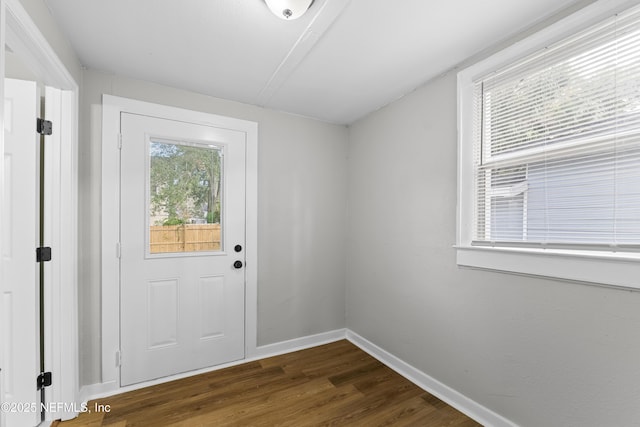 entryway featuring baseboards and dark wood-type flooring