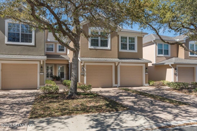 11856 Surfbird Cir Unit 41E, Jacksonville, FL 32256 - view of property with stucco siding, driveway, and a garage