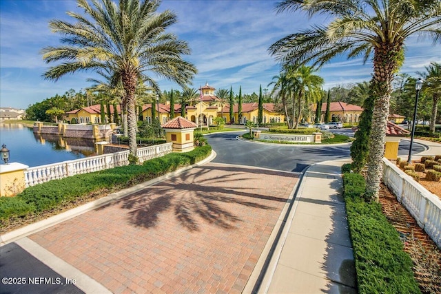 11856 Surfbird Cir Unit 41E, Jacksonville, FL 32256 - view of road featuring a water view, street lights, curbs, and a residential view