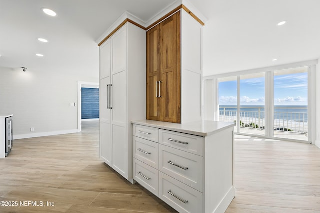 1601 Ocean Dr S Unit 410, Jacksonville Beach, FL 32250 - kitchen featuring light wood-style floors, beverage cooler, light countertops, a water view, and recessed lighting